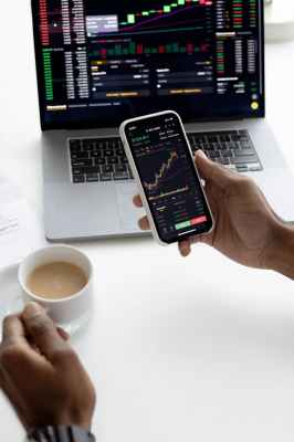 person holding mug and mobile phone